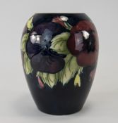 William Moorcroft Signed Pansy Designed Vase on blue ground, ovoid shape. 5.5 inches tall.