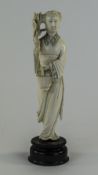 Japanese Late 19th Century Carved Ivory Figure of a Woman Carrying a Lotus Flower In Her Right Hand