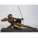 A Bacci and Bacci Art Deco Bronze Painted Plaster Sculpture of a Semi-Clad Female Archer on a Long