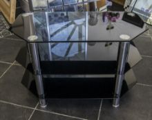 Modern Three Tier Black Glass TV Stand. Height 20 inches, width 31.5 inches.