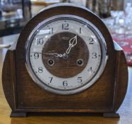 Oak Cased Mantle Clock, Height 9 inches, Width 9.75 inches.