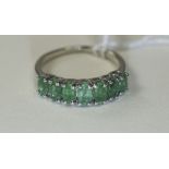 Emerald Band Ring, a row of seven, close set, oval cut emeralds of good colour,