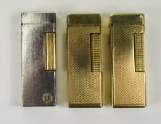 Dunhill Gold Plated and Vintage Petrol Lighters ( 3 ) In Total. British and USA Registration.