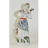 Soviet Russian Figure of a Young Woman in Traditional Dress, standing, with a bunch of flowers,