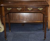 Mahogany Side Table, Two Freeze Drawers, Raised On Square Tapering Legs With Brass Casters.