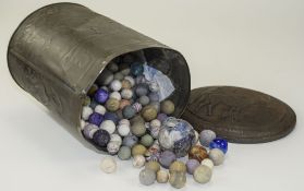 Metal Tin Containing A Collection Of Mixed Marbles.
