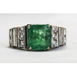 18ct White Gold Set Emerald And Diamond Ring. The Single Step Cut Emerald of Good Colour with