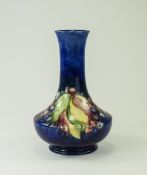 W. Moorcroft Footed Vase, Leaves and Berries Design on Blue Ground. c.1940's. 6.25 Inches High.