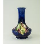 W. Moorcroft Footed Vase, Leaves and Berries Design on Blue Ground. c.1940's. 6.25 Inches High.