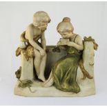 Royal Dux Group Figure of a Boy and Girl Seated, The Girl Playing a Musical Instrument. c.1900. Pink