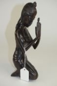 Indonesian - 20th Century Signed Wood Carving of a Young Woman In a Kneeing Position.