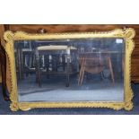 A Gilt Framed Shaped Rectangular Wall Mirror, Bevelled Mirror. 22 x 35 Inches.