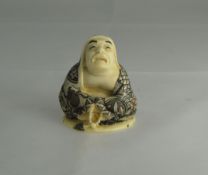 Japanese - Signed Early 20th Century Carved Ivory Netsuke of a Robed Man In a Sitting Position.
