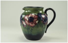 Moorcroft Tube lined and Signed Ovoid Shaped Jug ' Anemone ' Design on Green / Blue Ground,