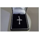 A 9ct White Gold Cross - Set with Diamonds. The Diamonds of Good Colour and Clarity.