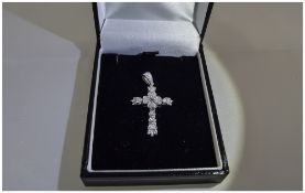 A 9ct White Gold Cross - Set with Diamonds. The Diamonds of Good Colour and Clarity.