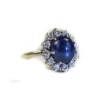 18ct White Gold Diamond And Sapphire Cluster Ring Central Cabochon Cut Sapphire Surrounded By 12