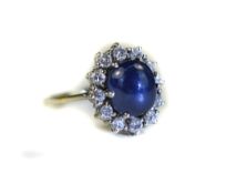 18ct White Gold Diamond And Sapphire Cluster Ring Central Cabochon Cut Sapphire Surrounded By 12