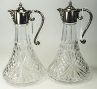 Pair Of Cut Glass And Silver Plated Claret Jugs, The Mounts WIth Hinged Tops And Mask Spouts.