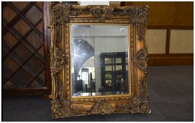 Modern Georgian Style Gilt Swept And Molded Wall Mirror With Bevelled Glass,