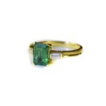18ct Gold Emerald And Diamond Ring Set With Central Emerald Between Two Baguette Cut Diamonds,