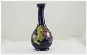 W. Moorcroft Signed Bottle Shaped Vase ' Clematis ' Design on Blue Ground. c.1938-1942.