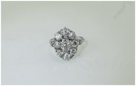 White Gold Diamond Cluster Ring Set With A Central Oval Cut Diamond Surrounded By Eight Old Round