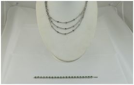 A Nice Quality Silver Triple Strand Necklace with Emerald Coloured Stones.