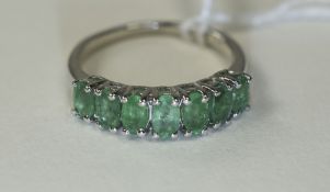 Emerald Band Ring, a row of seven, close set, oval cut emeralds of good colour,