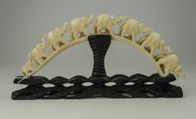 Japanese Late 19th Century Ivory Tusk Carving of a Group of Elephants Raised on a Black Ground,