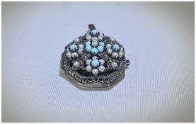 Art Deco Turquoise and Seed Pearl Locket, a geometric pendant in silver with openwork front,