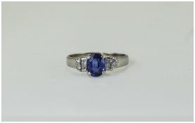 18ct White Gold Sapphire & Diamond Ring Set With A Central Oval Blue Sapphire Between Two Baguette