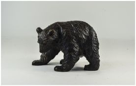 A Carved Black Forest Style Bear with Bead Eyes. 8.5 Inches Long, 6 Inches High.