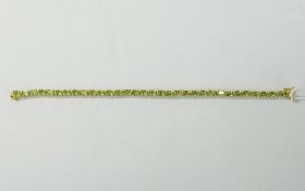Peridot Tennis Bracelet, oval cuts of the brilliant green peridot totalling 15.
