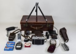 A Vintage Leather Case With Locks Containing A Collection Of Cameras And Camera Accessories.