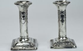 Edwardian Pair Of Silver Candlesticks, Decorated With Embossed Images Of Swags And Garlands,