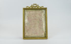 Antique Gilt Metal Photo Frame With A Swag And Ribbon Top Decoration To The Top Of The Photo Frame.