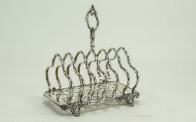 A Very Fine and Heavy Victorian Silver Plated Six Tier Toast Rack of Ornate Form.