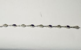 Amethyst Tennis Racket Bracelet, a line bracelet of rhodium vermeil and silver tennis rackets,