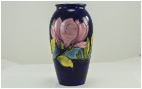 William Moorcroft Signed Ovoid Shaped Vase ' Pink Magnolia ' Pattern on Blue Ground.