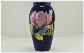 William Moorcroft Signed Ovoid Shaped Vase ' Pink Magnolia ' Pattern on Blue Ground. Signed In Green