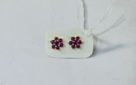 Ruby Floral Cluster Stud Earrings, each earring comprising seven round cut Burmese rubies in the