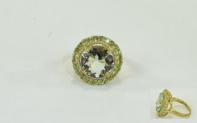 Green Amethyst and Peridot Ring, an 11ct round cut green amethyst framed by 1.75cts of round cut