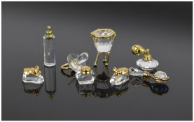 Swarvoski Cut Crystal Miniatures with gold plated mounts. 8 in total. Various subjects and sizes.
