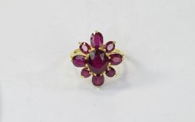 Ruby Cluster Flower Ring, 10.7cts of oval cut rubies comprising eight faceted ovals in two different
