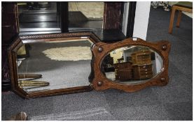 Two Early 20thC Oak Framed Mirrors one of shaped form with oval bevelled mirror.