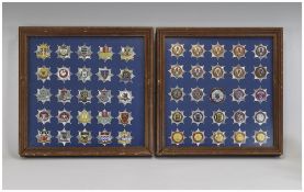 Two Glazed Wall Displays Containing 50 Fire Service Cap Badges,