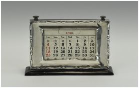 A 1920's Silver Framed Desk Calendar. With a wavy edge border and oak back.