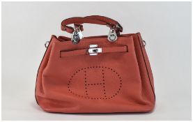 A Ladies Leather Coral Hand Bag, 3 compartments.