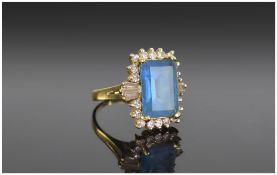 14ct Yellow Gold Set Blue Topaz and Diamond Ring. The emerald cut blue topaz of nice quality.